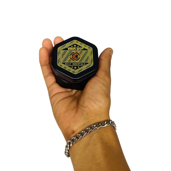 Hand holding a black container with a logo on a white background