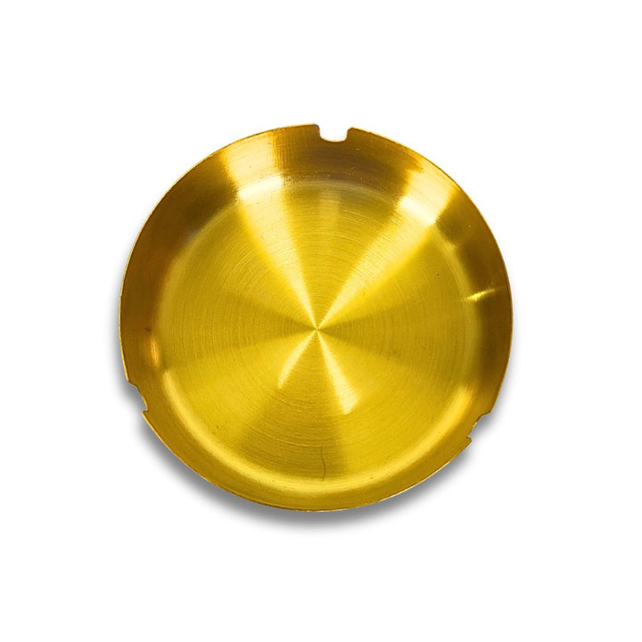 Gold metal ashtray on a white background