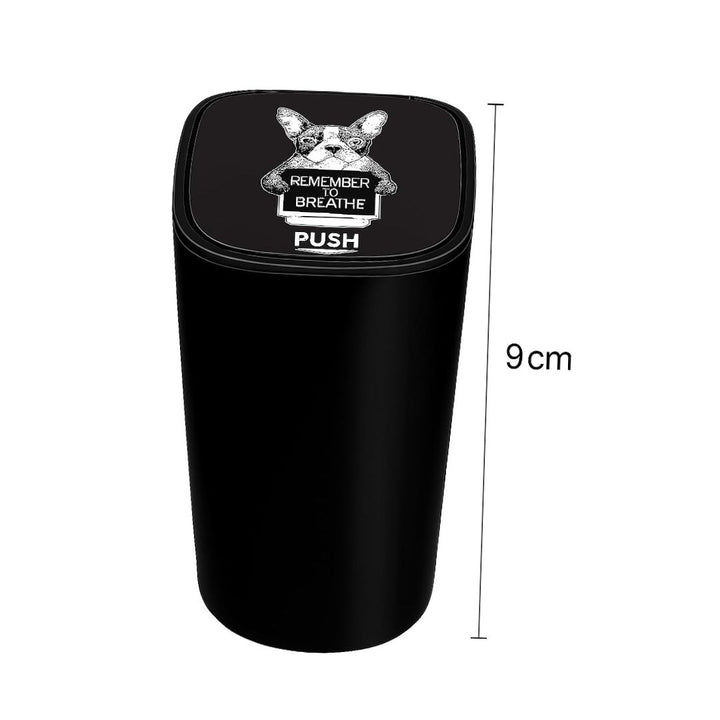 Black trash bin with a design and text on the lid, dimensions indicated.