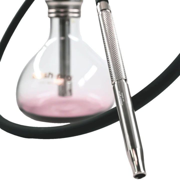 Close-up of a hookah with a glass bowl and metal hose on a white background
