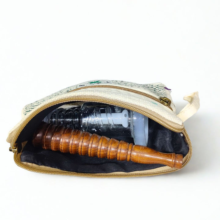 Open pouch with a wooden chillum and helios percolator bong inside on a white background