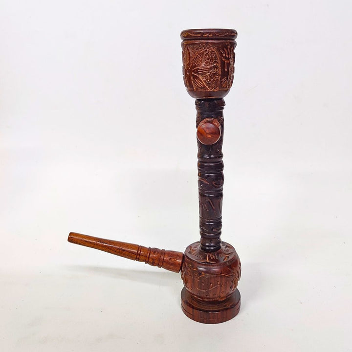 Wooden pipe with intricate carvings on a white background
