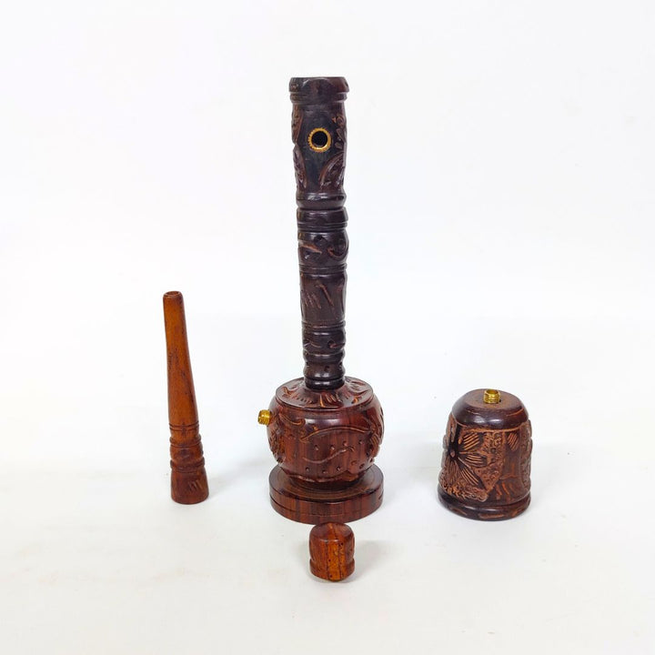 Wooden smoking pipe with decorative carvings on a white background