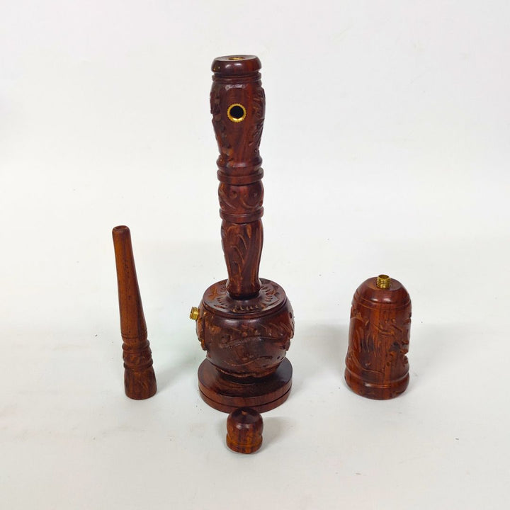 Wooden smoking pipe with decorative carvings on a white background