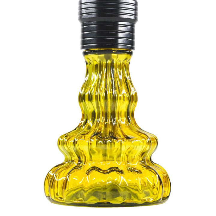 Yellow glass bottle with black cap on a white background