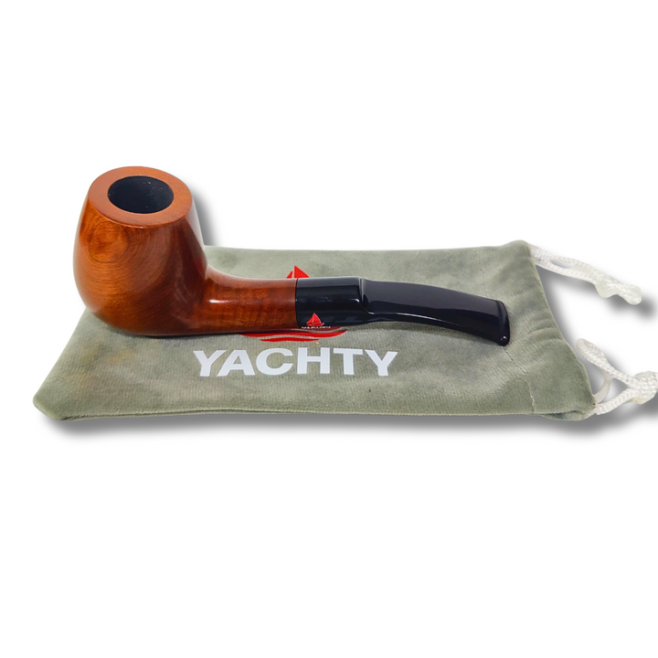 Wooden pipe with black accent on a green drawstring bag labeled 'YACHTY' on a white background