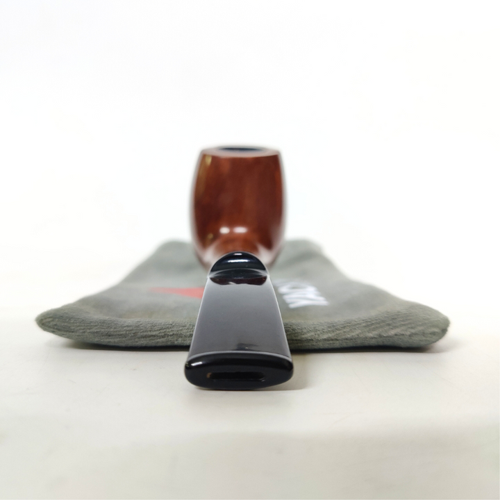 Wooden smoking pipe with black ferrule on a gray cloth background
