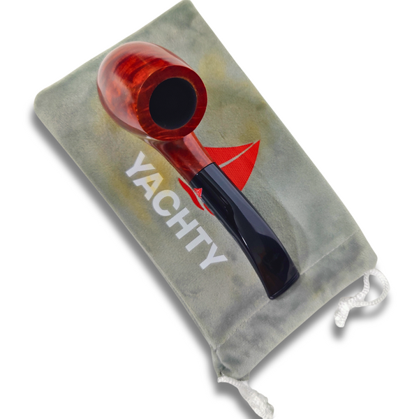 Red and black smoking pipe on a Yachty branded gray drawstring bag.