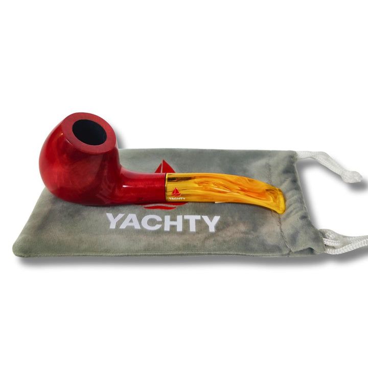 Red and gold pipe with 'Yachty' logo on a gray pouch