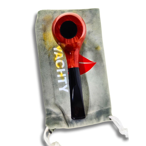Red and black smoking pipe on a gray drawstring bag with 'YACHTY' branding.