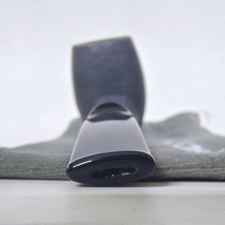 Black vacuum attachment on a gray Tobacco pipe with a white background